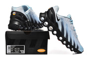 Light blue and black Nike Air Max DN sneakers displayed with a box showing a sample size label.
