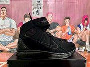 Side profile of a black high-top sneaker showing the ankle strap, tonal Swoosh, padded upper and layered outsole.