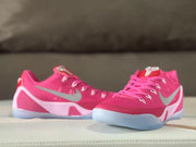 Pair of pink Kobe 9 sneakers shown from a front three-quarter angle.