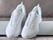 Pair of white Alo sneakers viewed from the front, highlighting the layered lace loops and padded tongues.