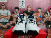 Front view showing the perforated toe areas, white laces, black toe accents, and blue detailing.