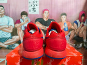 Rear view showing the red heel panels with embossed Nike branding and blue outsole accents.