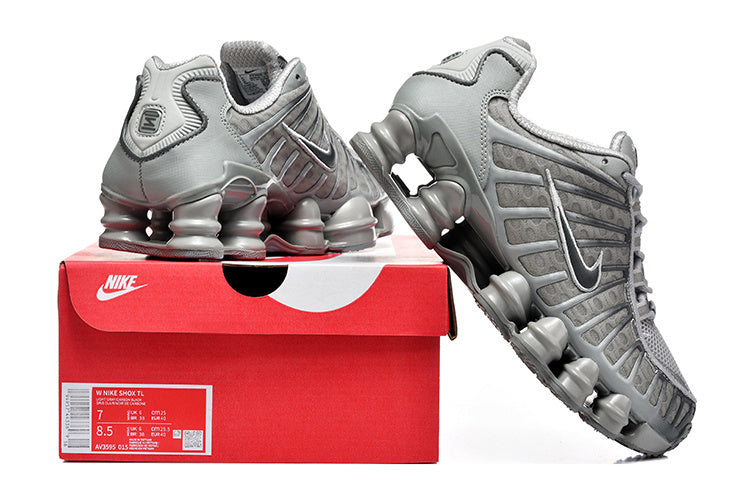 Grey Nike Shox TL sneakers displayed with a red Nike shoe box; the box label shows a sample size.