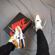 On-foot view of the Air Jordan 312 sneakers beside the shoebox