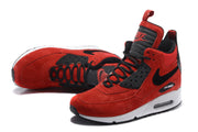 Angled view of red and black Nike Air Max 90 high-top sneakers with white midsoles.