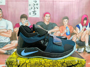 Side profile of a navy and black Nike basketball shoe with a blue side logo and forefoot straps.