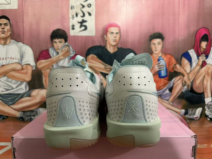 Rear view of light grey Nike G.T. Cut 3 basketball shoes with perforated heel panels and pale green-toned soles.