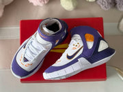 Top and side view of the sneakers displayed on a red shoebox.