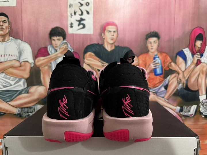 Rear view of black Nike basketball shoes with pink accents and pale pink midsoles.