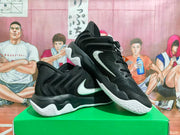 Angled view of black Nike basketball shoes with white Swoosh logos.