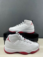 White and red Jordan Air Jordan 11 Retro Low sneakers shown from side and three-quarter angles.