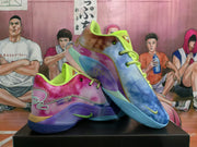 Angled view of multicolor Nike basketball sneakers showing contrasting side panels, lime accents, Monopoly-themed labels, and textured outsoles.