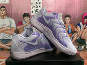 Angled view of a pair of lavender and white Nike basketball sneakers with purple side detailing and layered low-top construction.