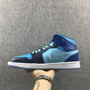Lateral profile of the sneaker showing its mid-top shape, blue side panel, navy overlays and white midsole.