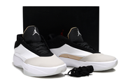White, black, and beige Jordan 40 shoes displayed together against a black backdrop.