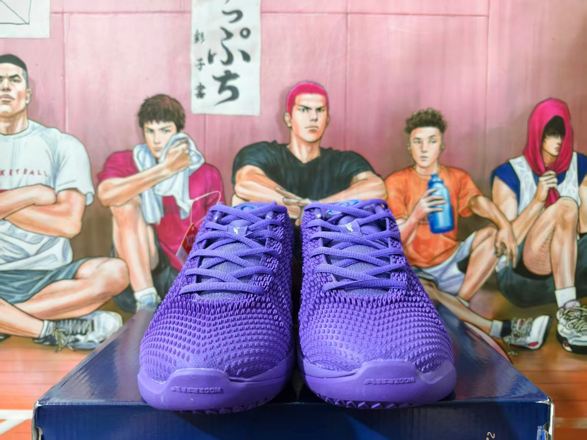 Pair of purple Nike basketball shoes shown from the front