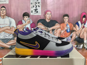 Side view of black and gray Nike sneakers with purple and yellow-pink outsole accents, displayed on a shoebox.