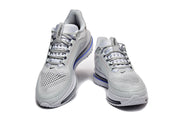Front views of a pair of light grey Nike Pegasus Premium lace-up shoes