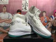 Pair of white high-top basketball shoes with teal outsoles, shown from the side