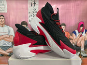 Angled view displaying the layered upper, sculpted midsole, and red outsole accents.
