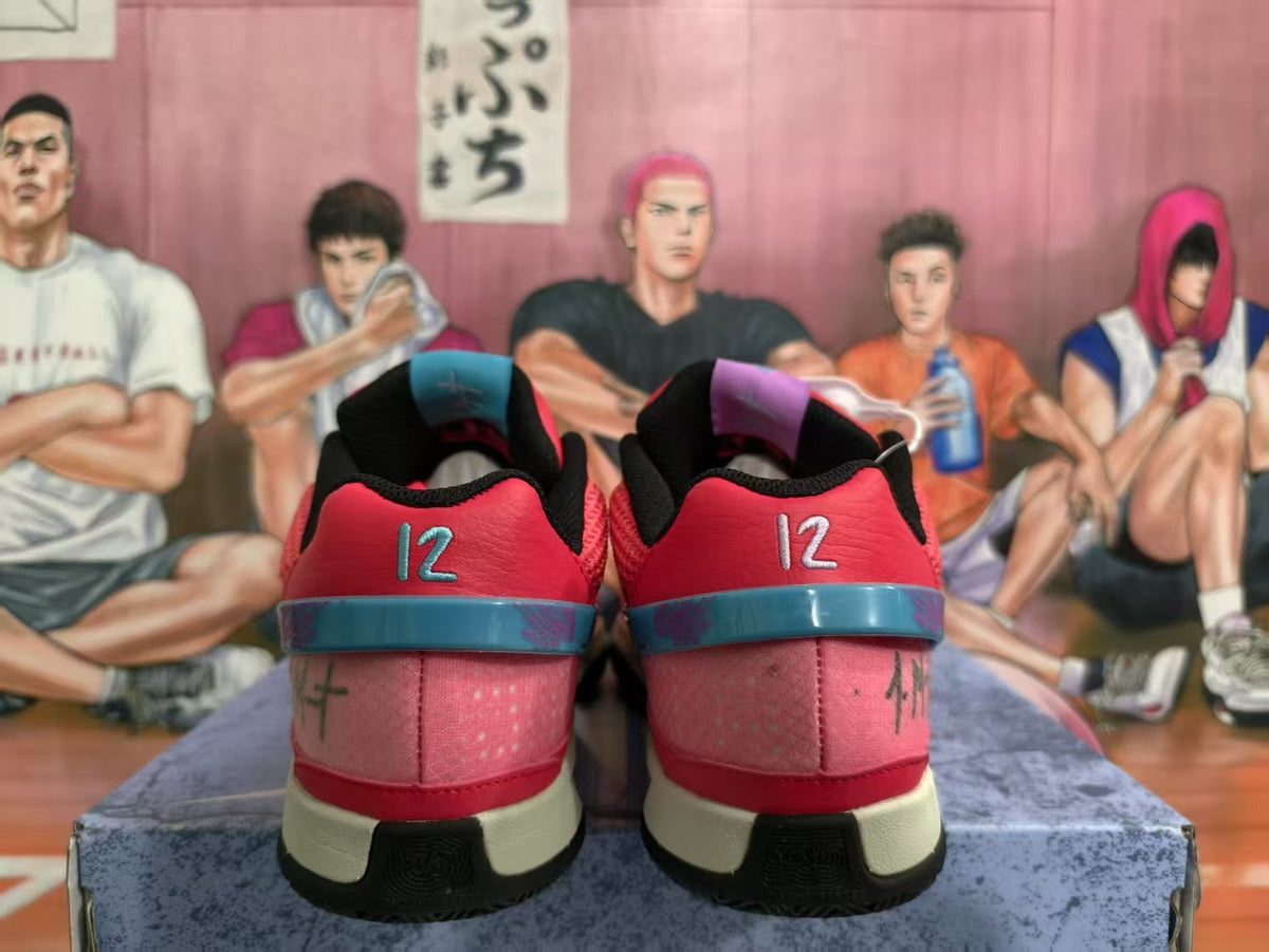 Rear view of red Nike sneakers showing blue heel bands, the number 12, and black rubber outsoles.