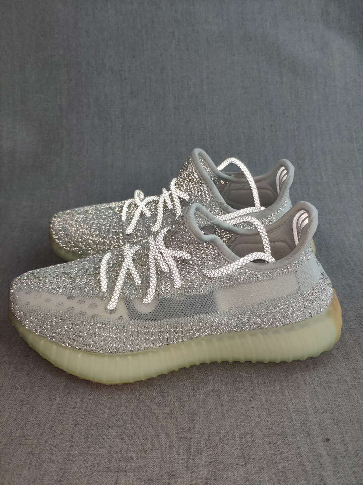 Pair of silver and white Yeezy 350 V2 sneakers shown from an angled side view.