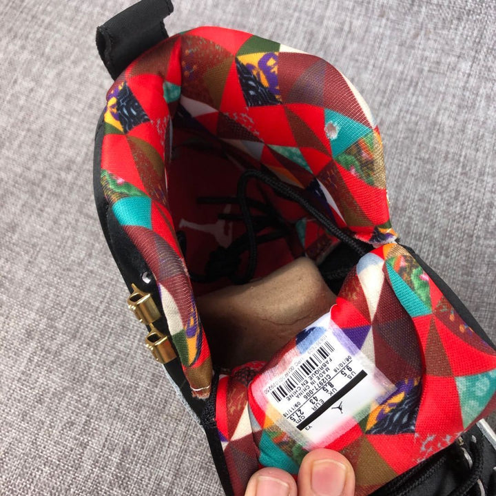 Close-up of the multicolor patterned lining, black laces, gold lace hardware, and interior size label.