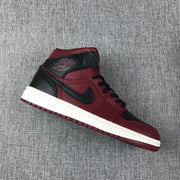 Single high-top sneaker shown diagonally with its black side logo panel and burgundy outsole.