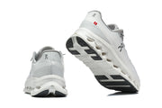 Rear and outsole views of the light gray On running shoes.