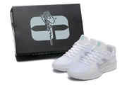 White basketball shoes beside a black box marked Sabrina Ionescu.