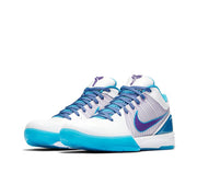 White and blue Nike Kobe 4 basketball sneakers with purple Swoosh branding and turquoise outsoles.