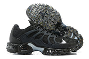 Pair of black Nike Air Max Plus sneakers showing the wavy cage and speckled outsole.