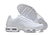 White Nike Air Max Plus VI sneakers shown from the side and outsole.