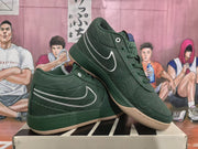 Angled view of green sneakers displaying the side Swoosh, tonal stitching, and padded collars.