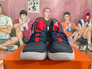 Front view of navy and red Nike basketball shoes with white soles