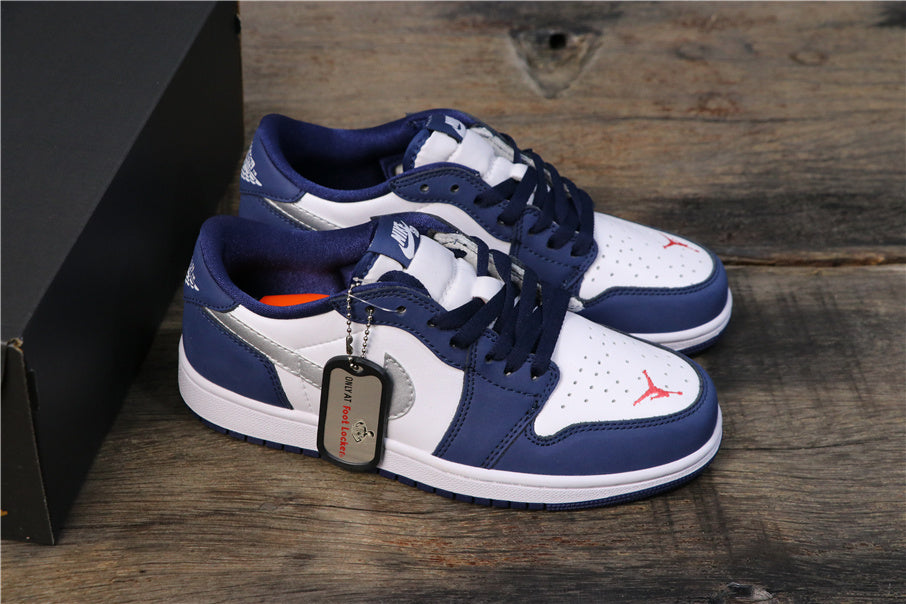 Pair of navy and white low-top sneakers shown with a black shoebox on a wooden surface.