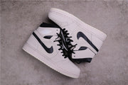 Pair of Summit White and black high-top sneakers viewed from above.