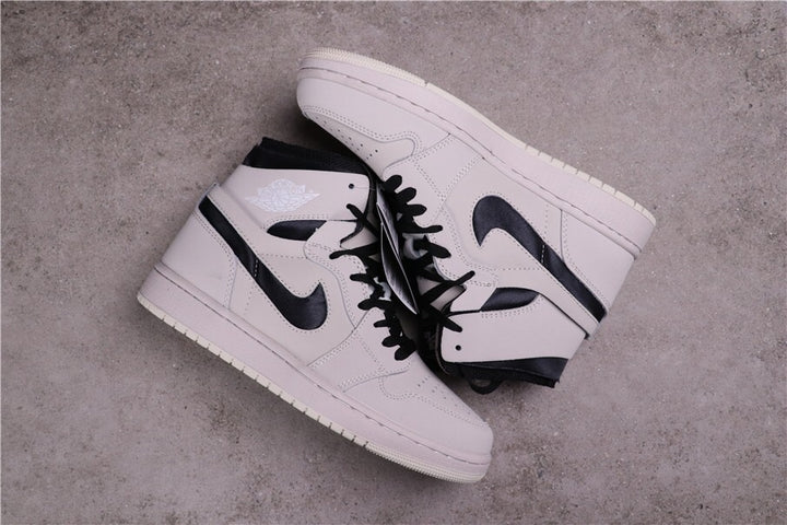 Pair of Summit White and black high-top sneakers viewed from above.