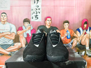 Front view of black Nike basketball shoes showing the laces and tongue logos.