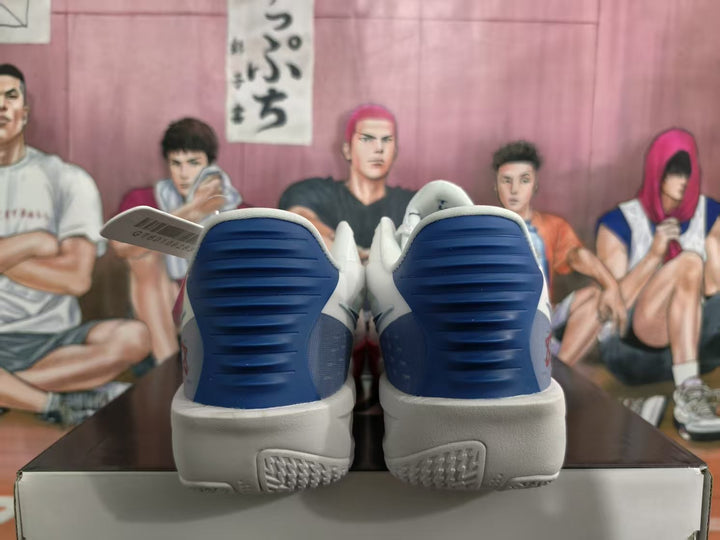 Rear view of white basketball shoes with blue heel details and light-colored soles