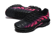 Angled top view of black and pink Nike Air Max Plus sneakers