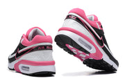 Heel and outsole views of black, white and pink Nike Air Max BW-style sneakers.