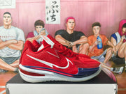 Side profile of a red Nike basketball shoe with a white Swoosh and white, red, and navy sole details.