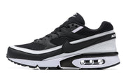 Side profile of a black Nike Air Max sneaker with white trim and a visible Air unit.