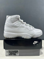 White high-top sneaker displayed on a black box; box label visibly shows EU 43, US 9.5, UK 8.5, and CM 27.5.