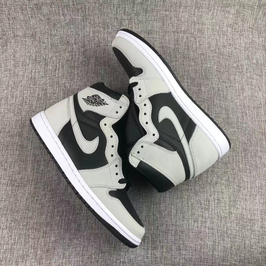 Pair of black and grey high-top sneakers shown from an angled top view.