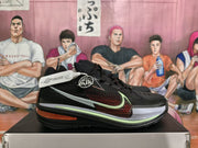 Side view showing the black textured upper, red patterned panel, white and pale green accents, and visible Nike swoosh.