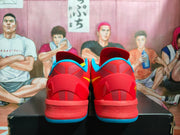Rear view of red basketball sneakers showing blue collar and outsole details with yellow side accents.