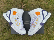 Top view of the pair showing the patterned forefoot and gold Swoosh details