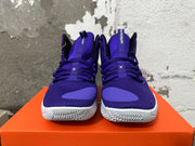Front view of purple lace-up high-top basketball shoes with white soles